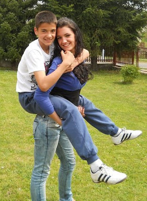 Young boy giving girl a piggyback ride.