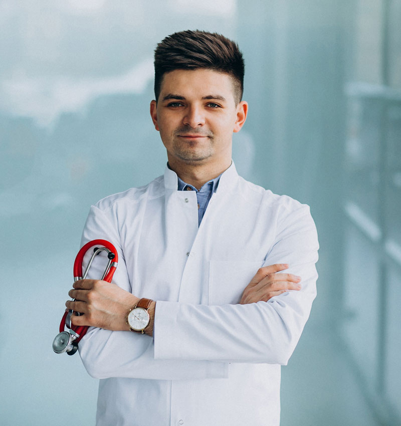 A man in white lab coat holding red wrench.