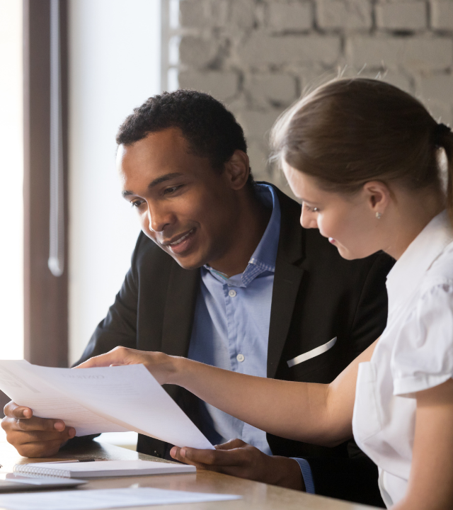 A man and woman looking at papers together.